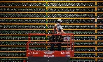 A massive cryptocurrency mining farm with rows of mining rigs under cooling systems